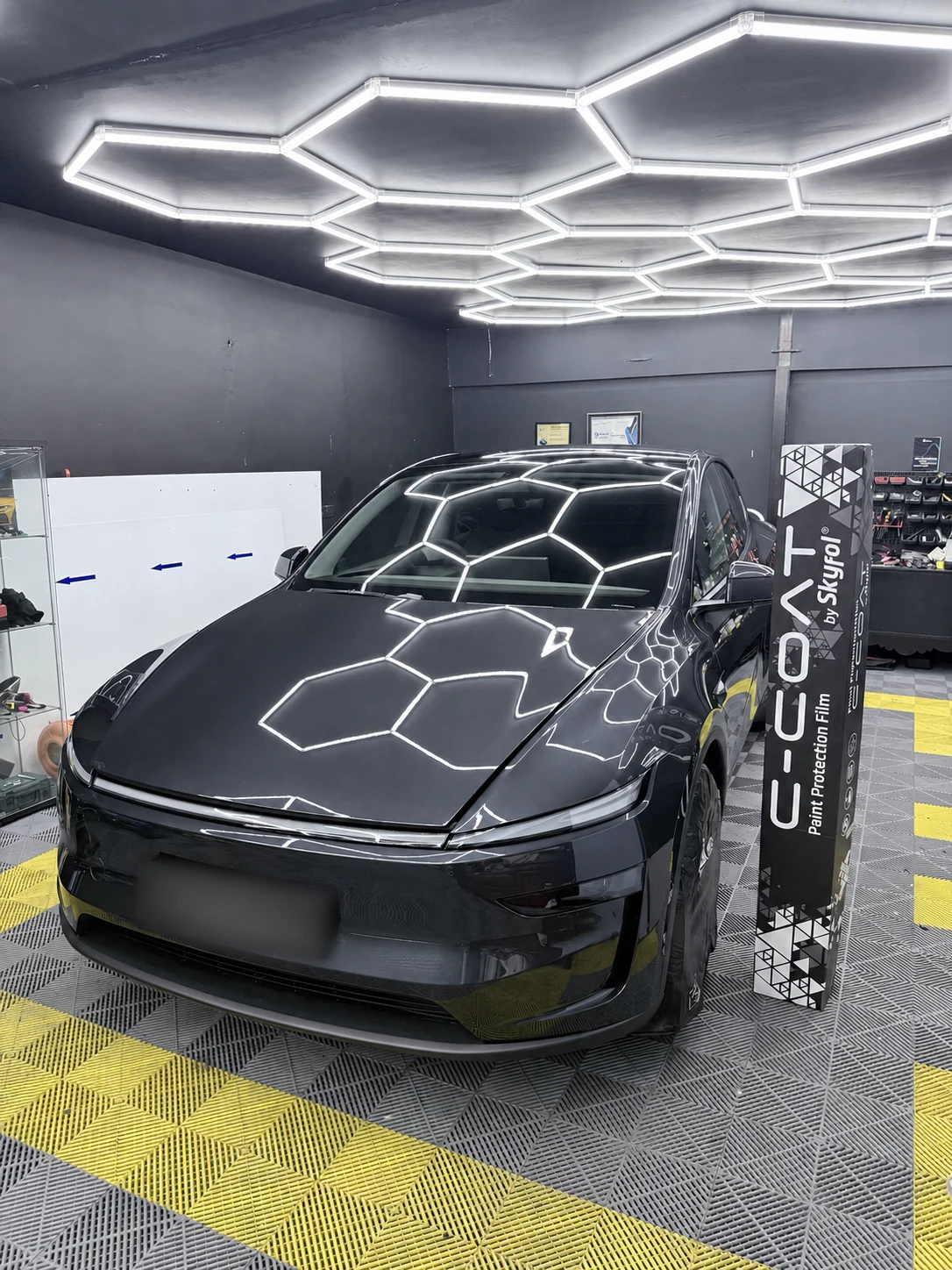 Black Tesla Model Y after full paint protection film coverage in the CarDetail Lab workshop